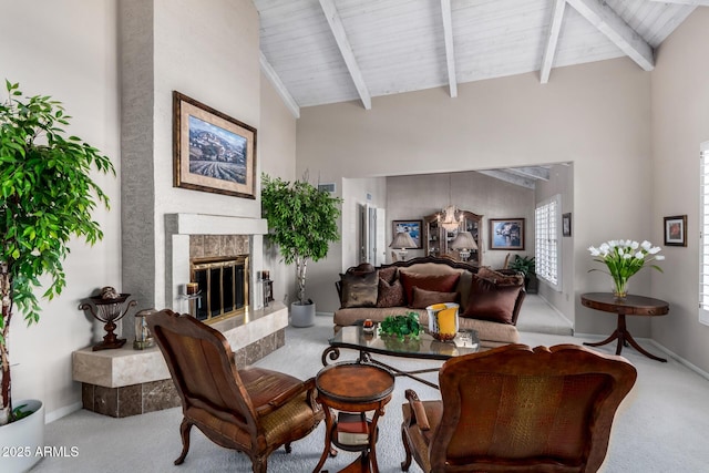 living room featuring a premium fireplace, baseboards, carpet, and beamed ceiling