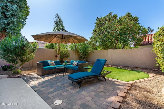 view of patio featuring an outdoor living space and a fenced backyard