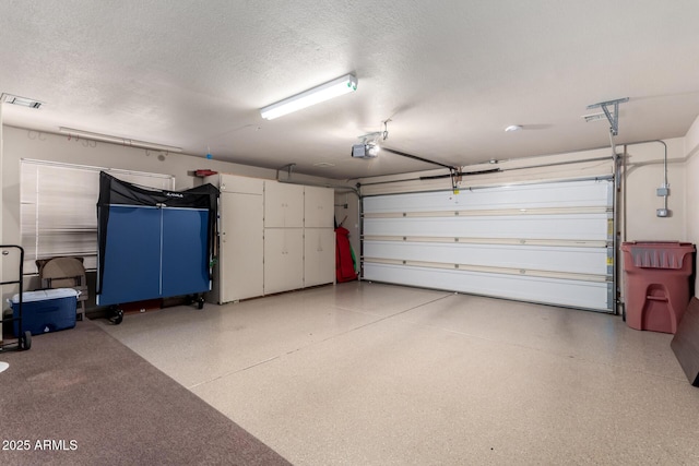 garage with visible vents and a garage door opener