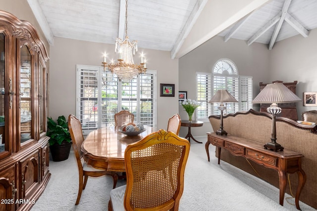 carpeted dining room featuring a notable chandelier and lofted ceiling with beams