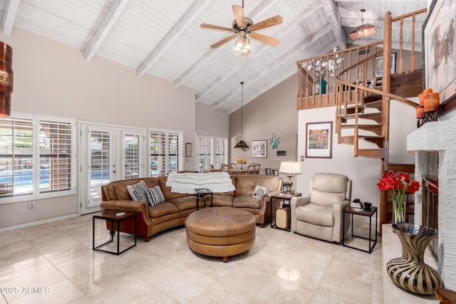 living area with a stone fireplace, beam ceiling, and a wealth of natural light