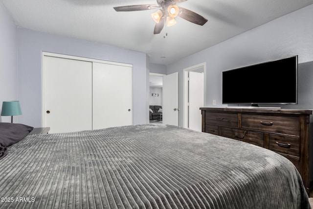 bedroom featuring ceiling fan and a closet