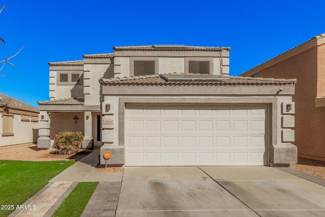 mediterranean / spanish-style house featuring concrete driveway, a tile roof, and stucco siding