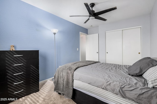 carpeted bedroom with a closet and a ceiling fan