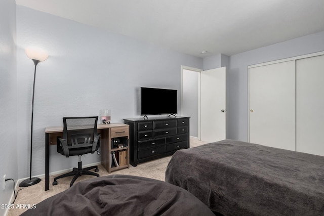 bedroom featuring a closet and light colored carpet