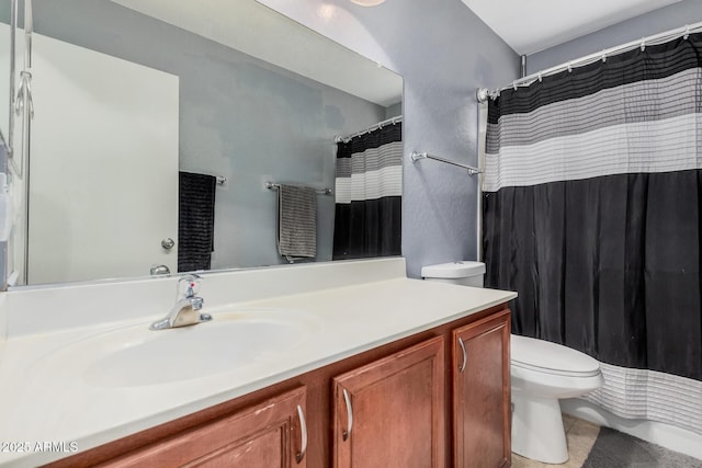 bathroom featuring curtained shower, vanity, and toilet