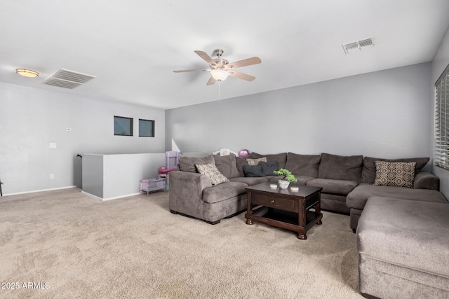 carpeted living room with ceiling fan, visible vents, and baseboards