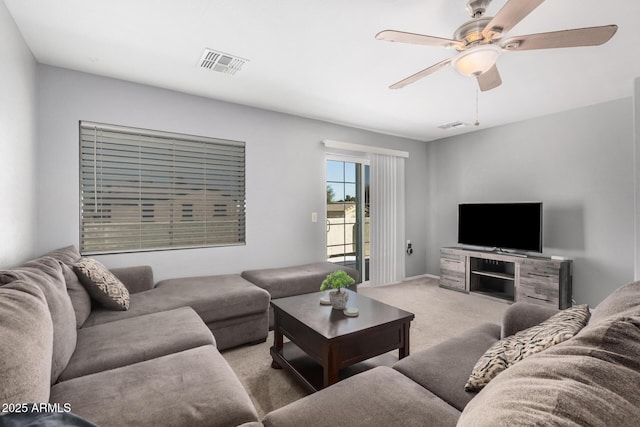 living area with ceiling fan, carpet floors, and visible vents