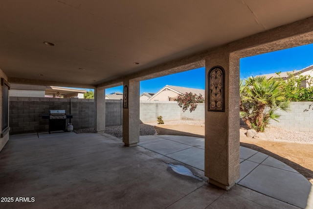 view of patio / terrace with a fenced backyard and a grill