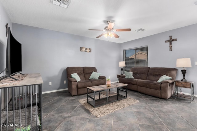 tiled living area with baseboards, visible vents, and a ceiling fan