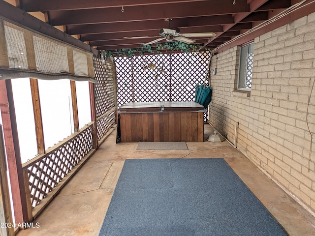 view of patio / terrace featuring a hot tub and a ceiling fan