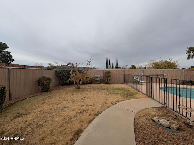 view of yard with a fenced in pool and a fenced backyard