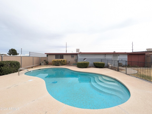 view of pool featuring a patio area, fence, and a fenced in pool