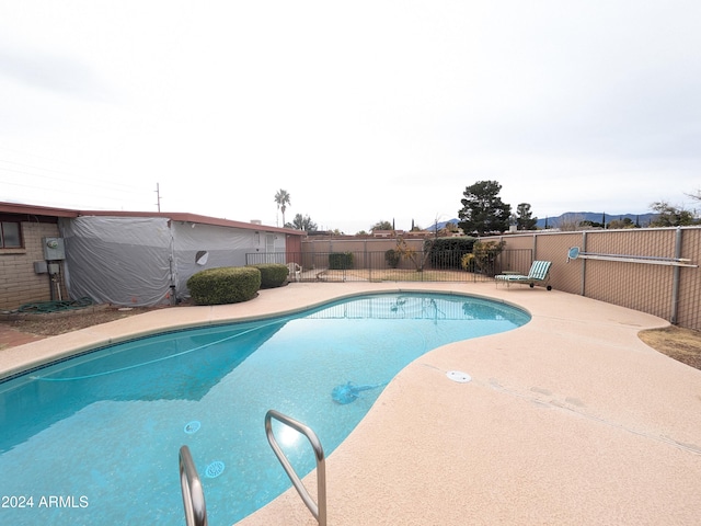 view of swimming pool with a fenced in pool, a patio area, and fence