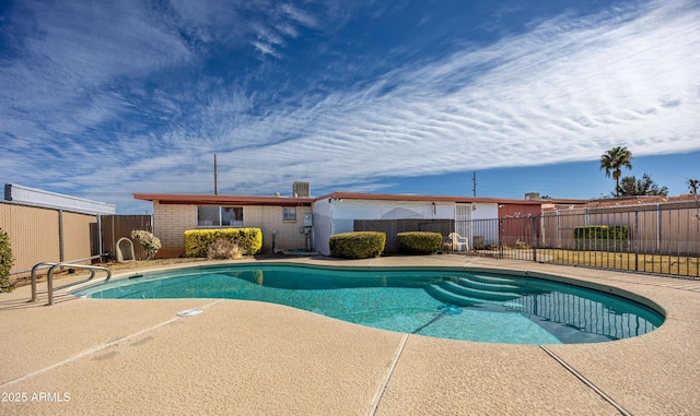 view of swimming pool featuring a patio area, fence, and a fenced in pool