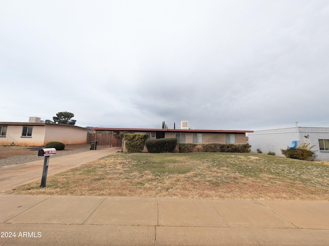 ranch-style home with a front yard