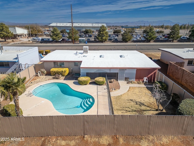 view of swimming pool featuring a fenced in pool, a patio area, a fenced backyard, and a mountain view