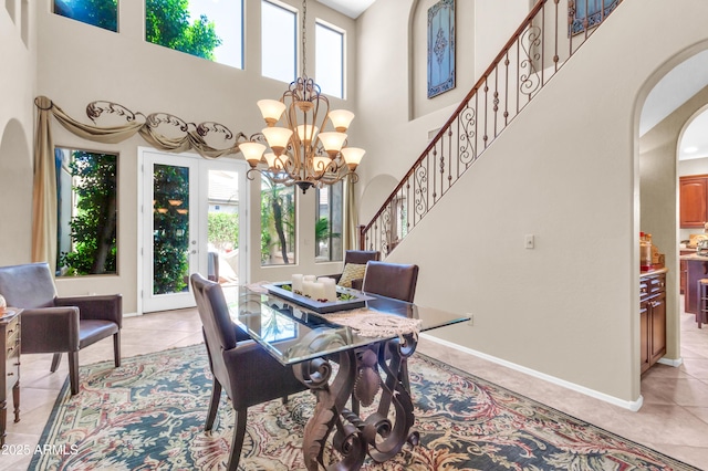 2383 E Zion Way, Chandler, AZ 85249 - dining area featuring healthy amount of natural light, arched walkways, a high ceiling, a chandelier, and light tile patterned floors