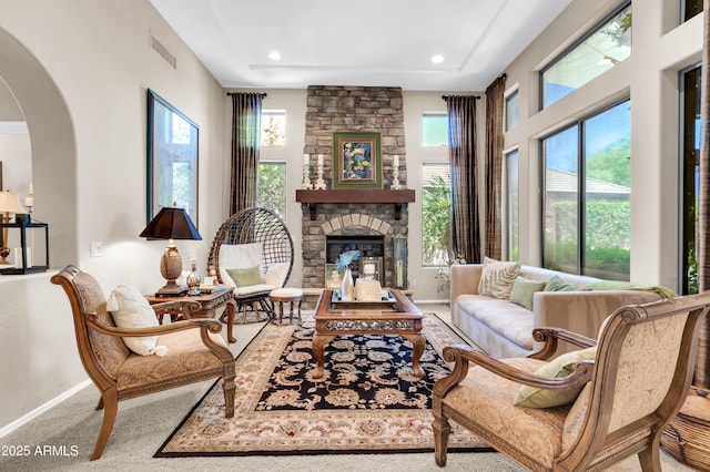 2383 E Zion Way, Chandler, AZ 85249 - living room with arched walkways, a stone fireplace, carpet floors, a raised ceiling, and recessed lighting