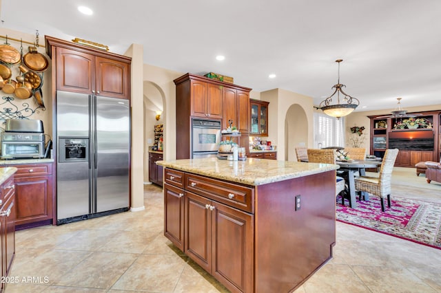 2383 E Zion Way, Chandler, AZ 85249 - kitchen with stainless steel appliances, arched walkways, light stone countertops, a kitchen island, and hanging light fixtures