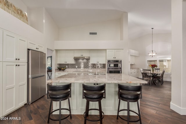 kitchen with white cabinetry, sink, stainless steel appliances, dark hardwood / wood-style floors, and decorative light fixtures