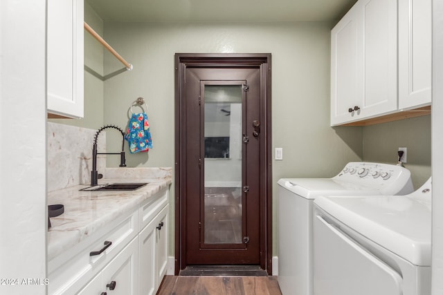 washroom with cabinets, wood-type flooring, separate washer and dryer, and sink