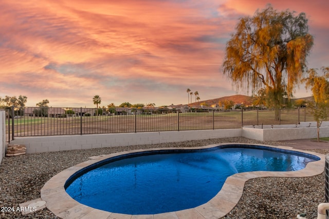 view of pool at dusk