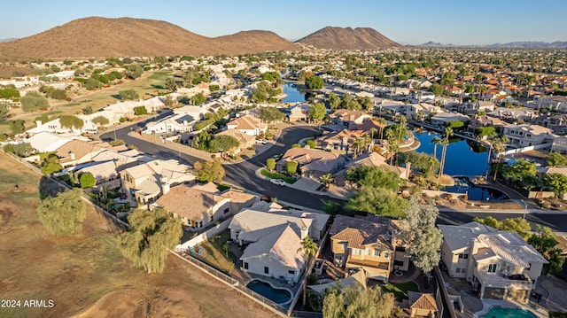 birds eye view of property featuring a water and mountain view