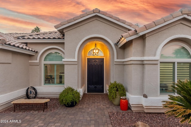 view of exterior entry at dusk