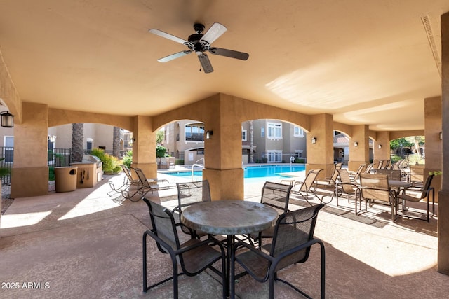 8245 E Bell Rd Unit 133, Scottsdale, AZ 85260 - view of patio featuring fence, a community pool, and a ceiling fan