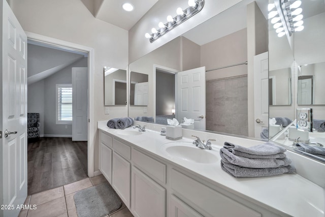 8245 E Bell Rd Unit 133, Scottsdale, AZ 85260 - full bath with tile patterned flooring, double vanity, vaulted ceiling, and a sink