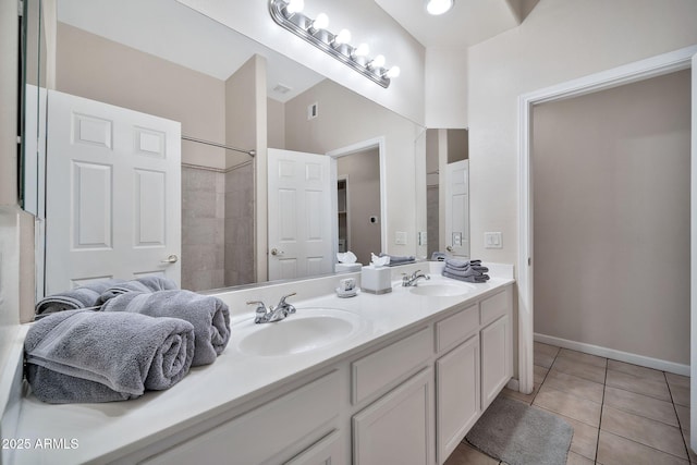 8245 E Bell Rd Unit 133, Scottsdale, AZ 85260 - bathroom featuring a sink, baseboards, double vanity, and tile patterned flooring