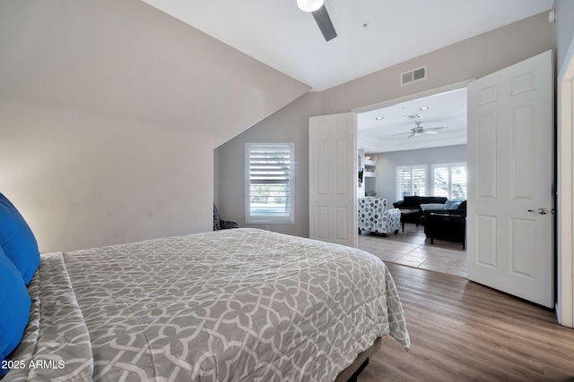 8245 E Bell Rd Unit 133, Scottsdale, AZ 85260 - bedroom featuring visible vents, a ceiling fan, and wood finished floors