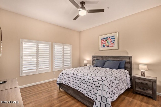 8245 E Bell Rd Unit 133, Scottsdale, AZ 85260 - bedroom with ceiling fan, baseboards, and wood finished floors