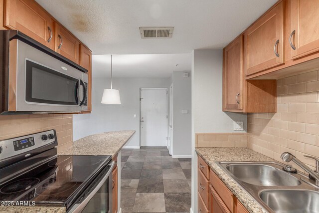 200 E Southern Ave Unit 226, Tempe, AZ 85282 - kitchen featuring stainless steel appliances, a sink, brown cabinets, and baseboards