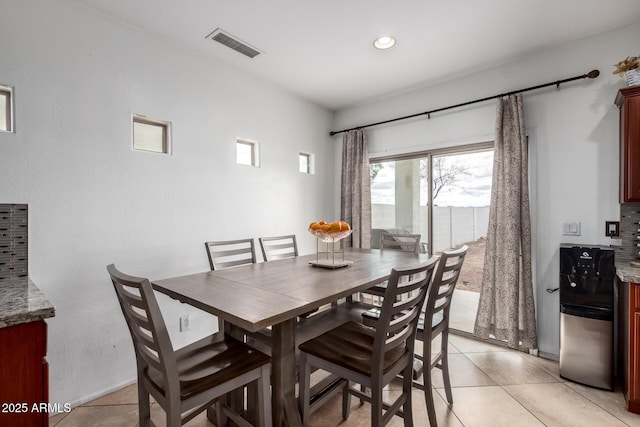 dining space with light tile patterned flooring and visible vents