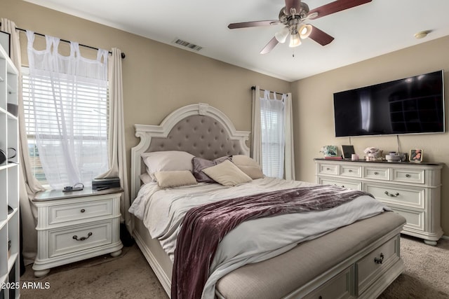 bedroom featuring visible vents, carpet floors, and ceiling fan