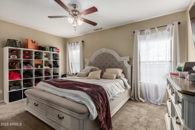 bedroom featuring light carpet, visible vents, baseboards, and a ceiling fan