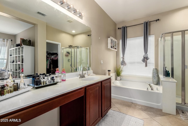 bathroom with visible vents, a shower stall, tile patterned flooring, a bath, and vanity