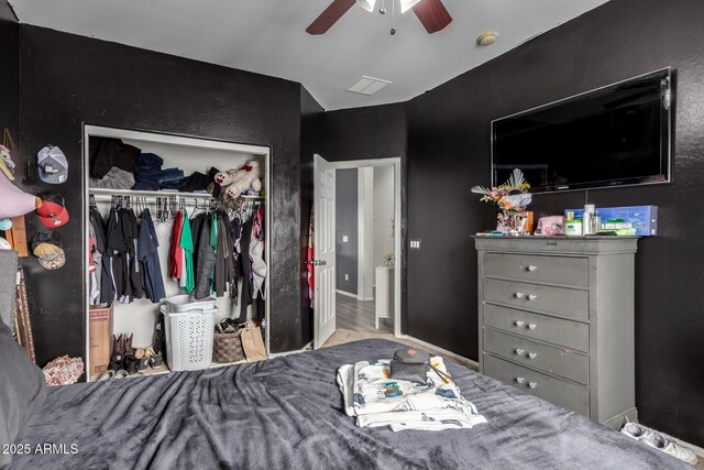 bedroom featuring baseboards, a closet, and ceiling fan