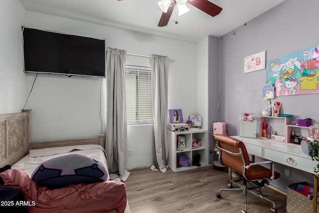 bedroom with wood finished floors and a ceiling fan