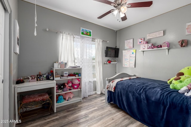 bedroom featuring a ceiling fan and wood finished floors