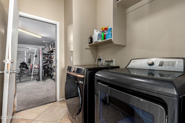 laundry room featuring light tile patterned floors, laundry area, and washer and dryer