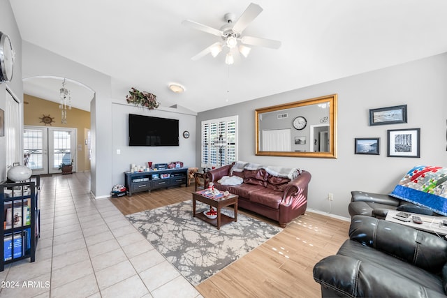 living room featuring light hardwood / wood-style flooring, lofted ceiling, and ceiling fan