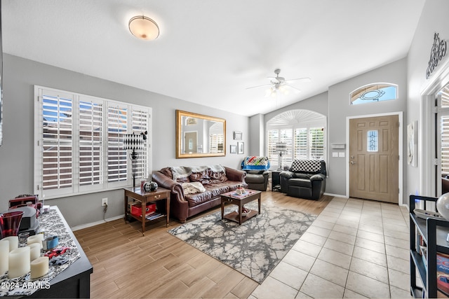 living room with lofted ceiling, light hardwood / wood-style floors, and ceiling fan