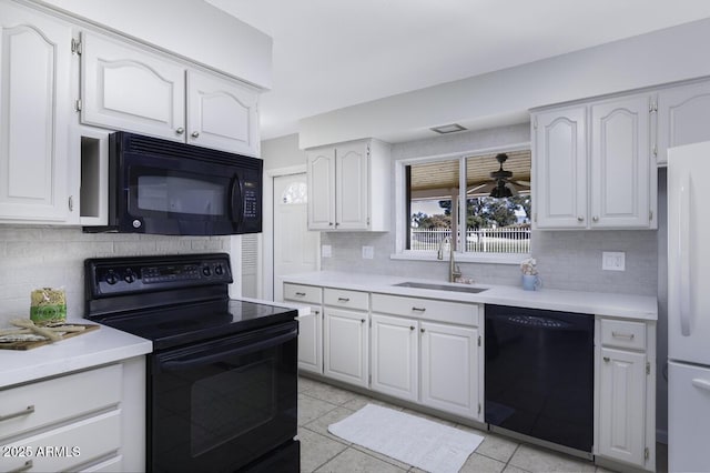 kitchen featuring white cabinetry, sink, and black appliances