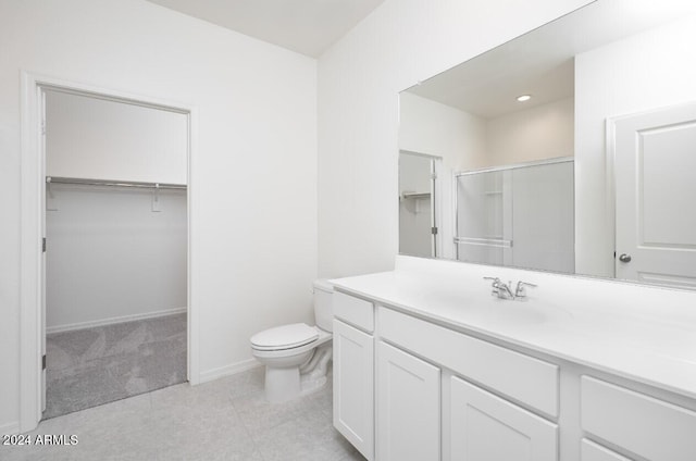 bathroom featuring tile patterned floors, vanity, an enclosed shower, and toilet