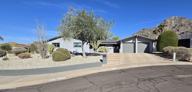 2237 E Nicolet Ave, Phoenix, AZ 85020 - view of front facade featuring roof mounted solar panels, stucco siding, concrete driveway, and a garage