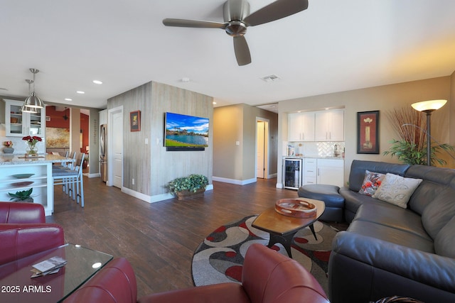 living room featuring ceiling fan, dark hardwood / wood-style flooring, and wine cooler