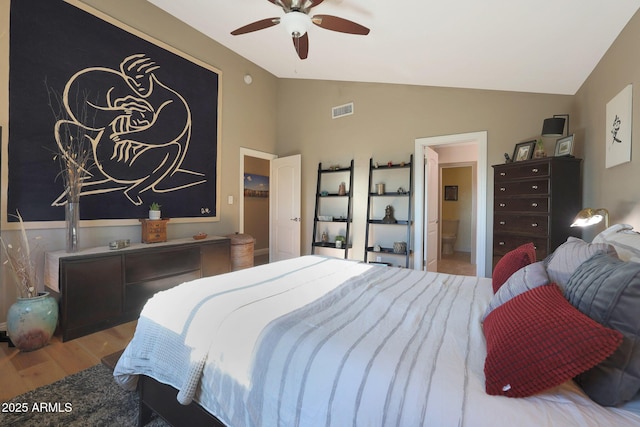 bedroom featuring ensuite bath, ceiling fan, light hardwood / wood-style floors, and lofted ceiling